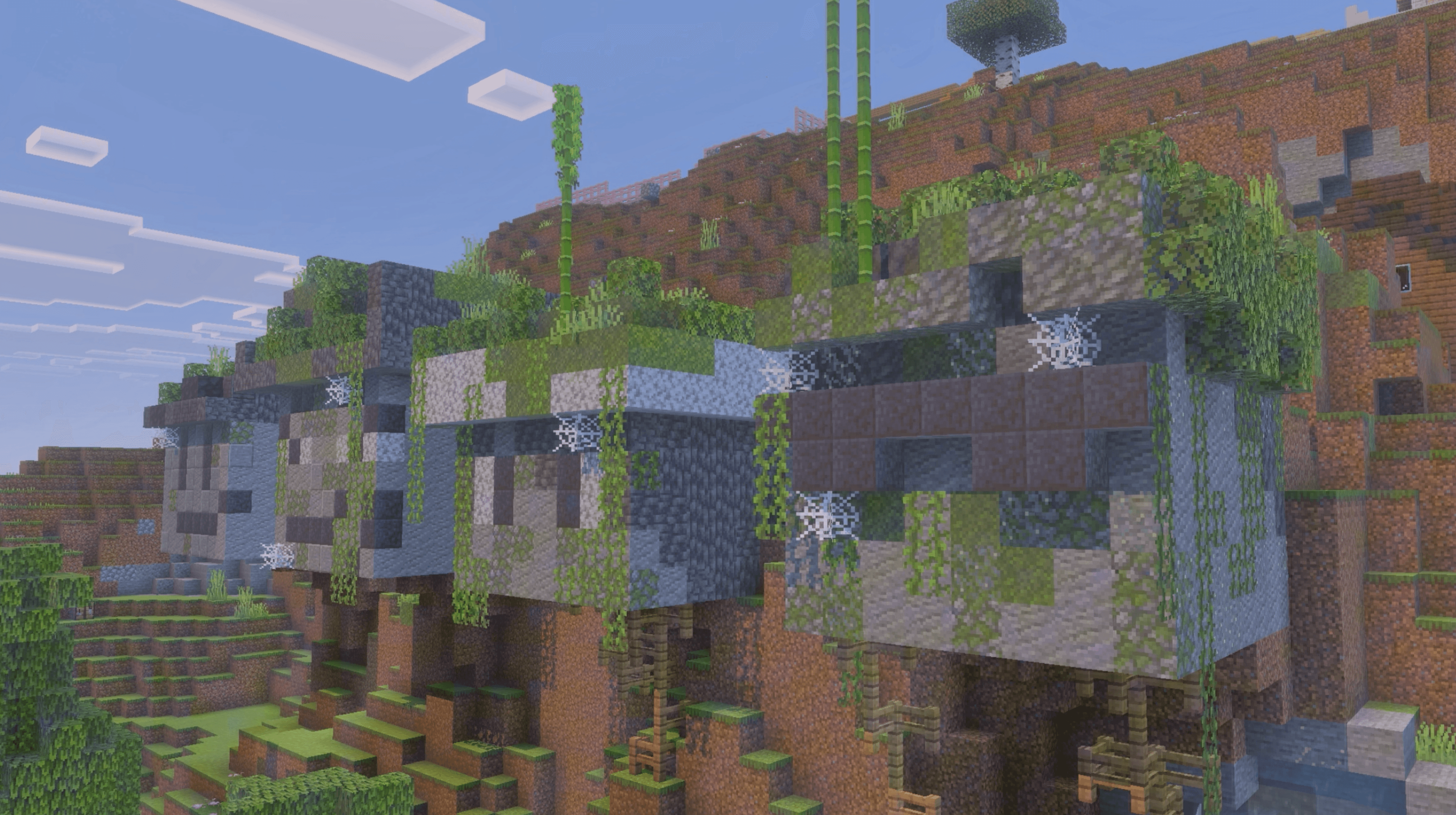 Player-built structures covered in vegetation on a Trimere hillside.